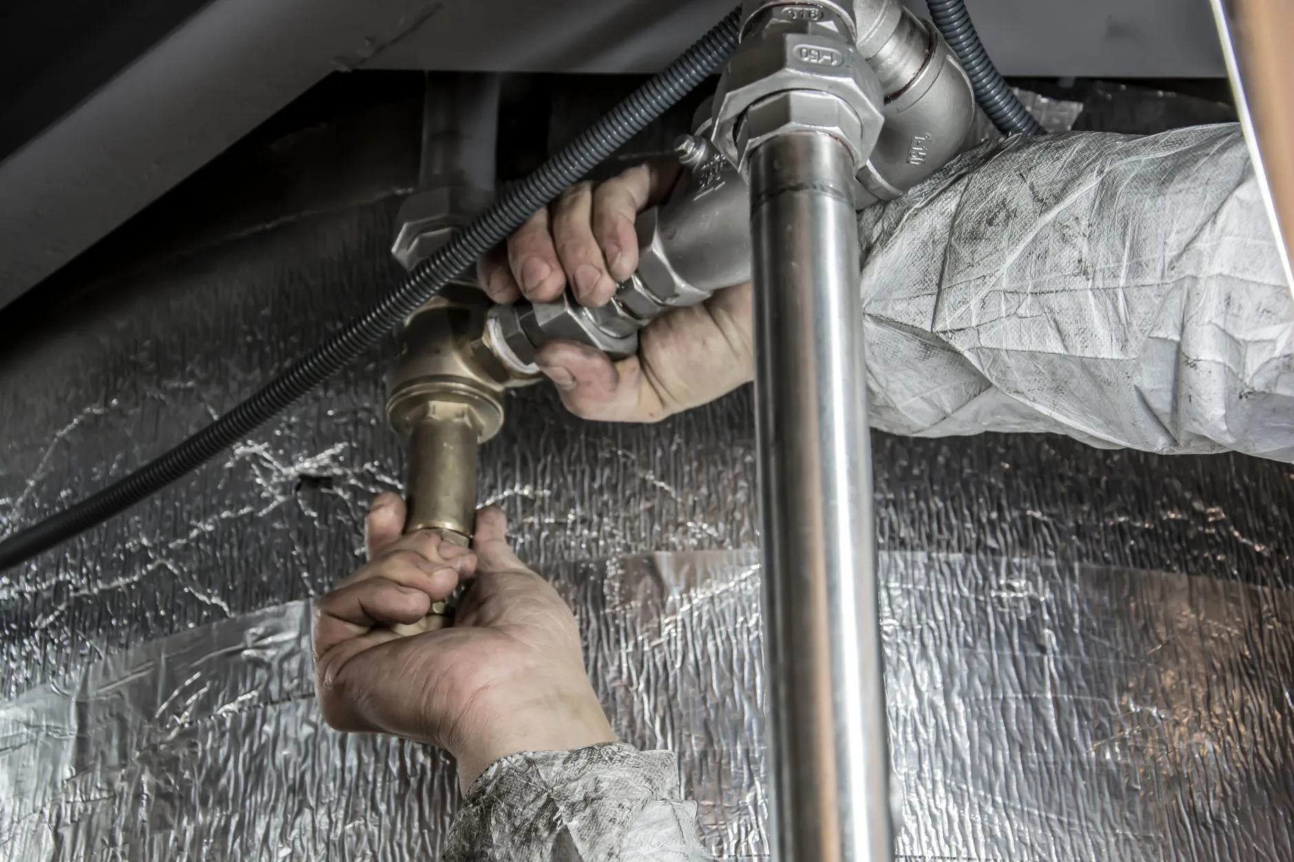 Adelaide plumber clearing a blocked drain with professional tools